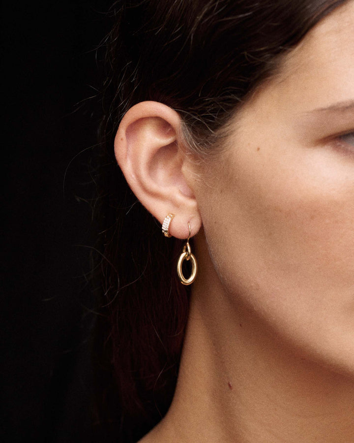 18K Gold Diamond Huggie Hoop Earrings styled on model with gold drop earring - On Model | IPPOLITA